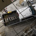 Top view of a white pickup truck at a construction site