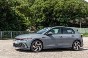Grey Volkswagen Golf GTI 2022 outside near the forest in a parking lot