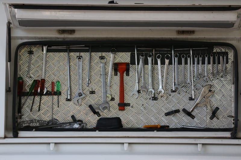 Motor Hills | How to Stop a Car Window from Squeaking (Step-By-Step Guide) Car tools stored on shelves for hanging car repair tools, keys, screwdrivers, nuts, and hammers