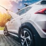 Motor Hills | High-Pressure Washing for Washing a Car: A Good Idea? Man washing his car with high pressurized water outside in the sun