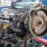 Motor Hills | Transmission Rebuild Vs Replace: Which Is Better? Automatic gearbox transmission on a workbench at a car repair shop