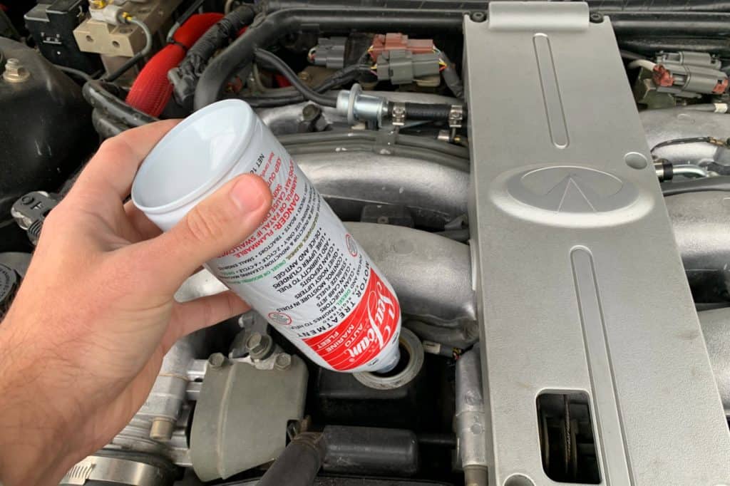 Motor Hills | Is Seafoam Good For Your Engine? Seafoam bottle being poured into the crankcase oil hole of an engine block