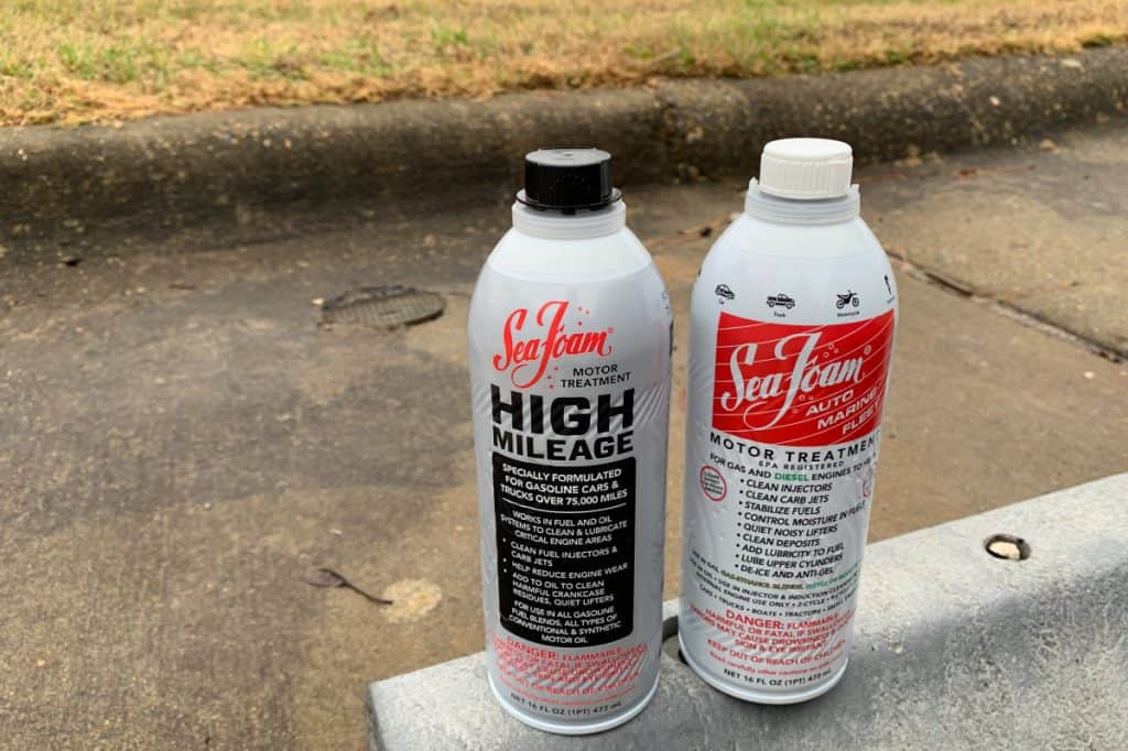 Motor Hills | Is Seafoam Good For Your Engine? Two SeaFoam bottles side by side high mileage and regular motor treatment bottles on parking lot