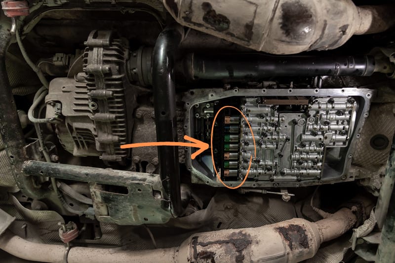 Bottom view of the automatic transmission with the pan removed and the solenoids highlighted