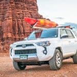 White Toyota 4Runner 2017 with a kayak on roof racks out in the desert going off-roading in Potash, Utah USA
