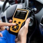 Motor Hills | Are OBD2 Car Tool Scanners Accurate? Automobile service technician using an OBDII OBD2 diagnostic scan tool to check for DTCs