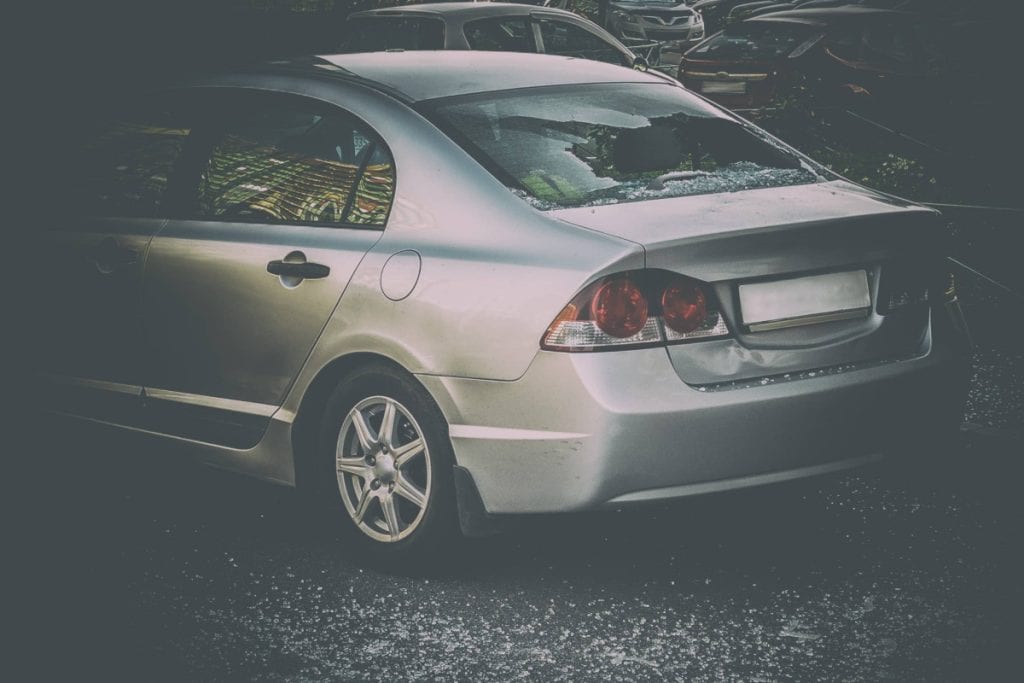 Motor Hills | Why Are Used Honda Civics So Expensive? Honda Civic with a broken rear glass