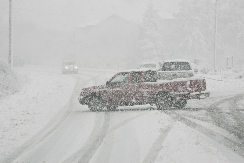 Pickup truck sliding in a snowstorm