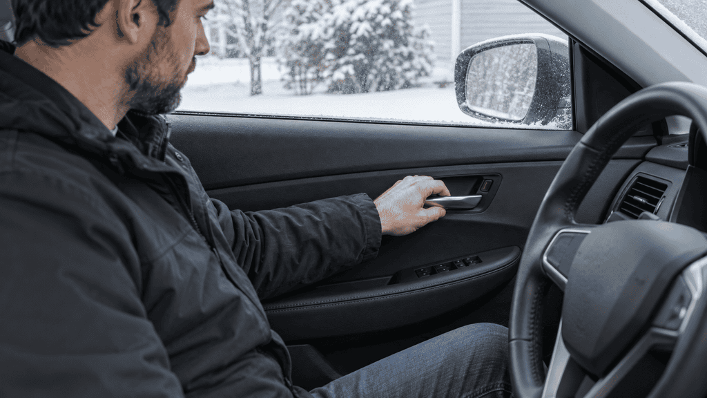 Motor Hills | How to Fix a Car Door That Won't Open from the Inside Driver pulling the interior door handle to release the car door