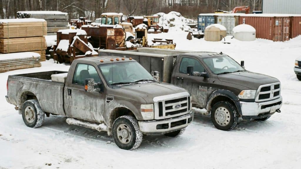 Motor Hills | Winter Truck Maintenance Checklist 2026 trucks parked in a winter workyard