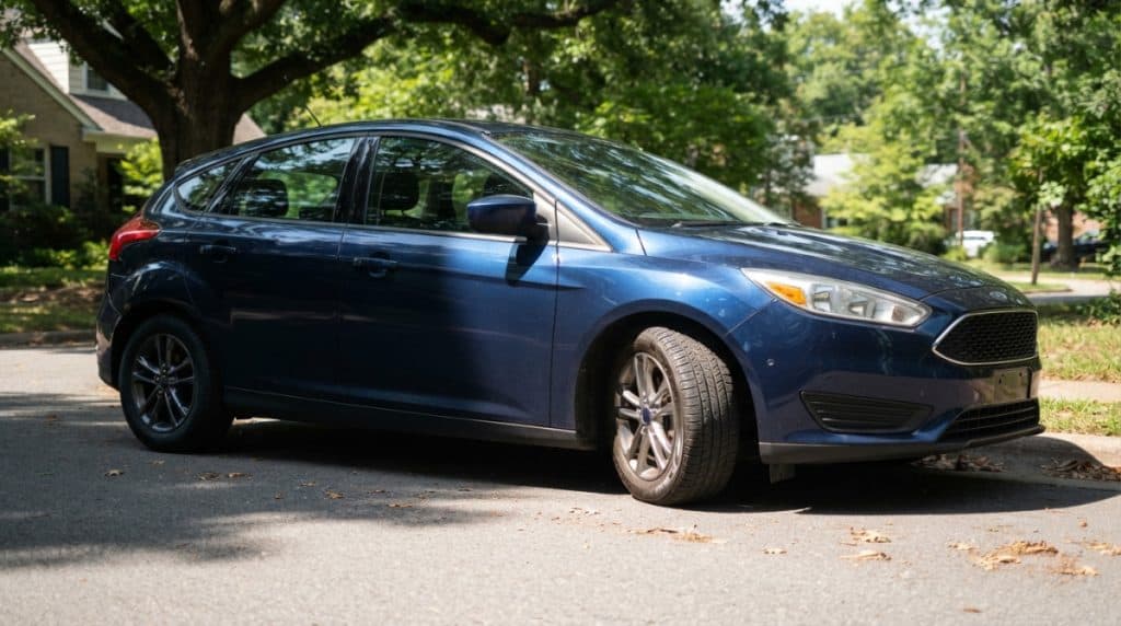 Motor Hills | Should You Let Air Out of Your Tires in Hot Weather? Parked car with sunlit and shaded tires during a summer tire pressure check
